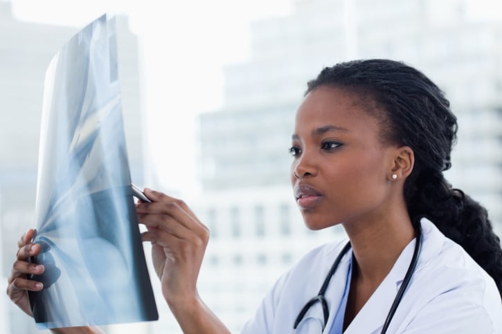African American woman doctor looking at xray