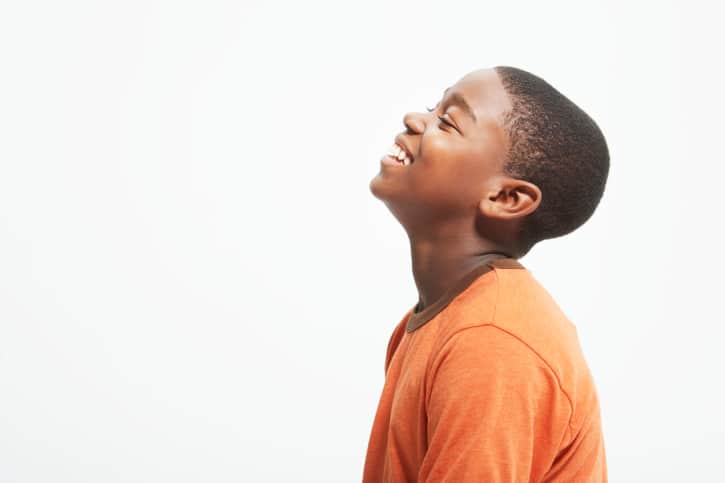 side profile of teen boy smiling