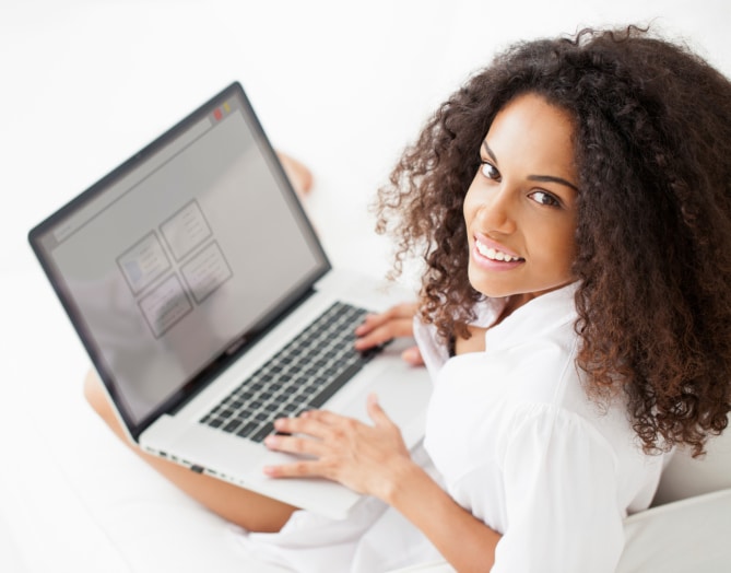 african american woman sitting with laptop on her lap