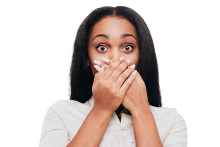 woman covering mouth