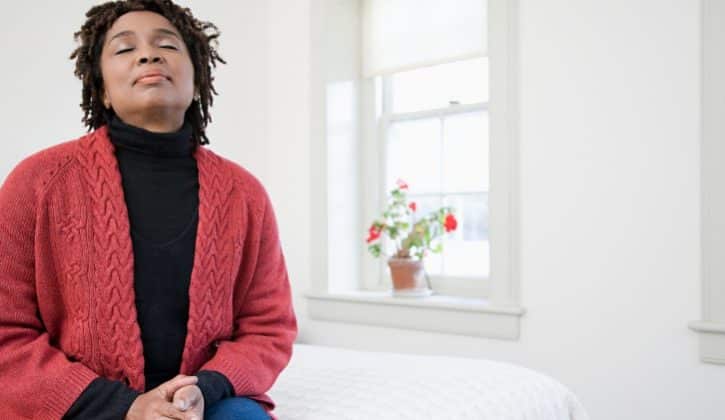 African American Black woman older meditating breathing peaceful