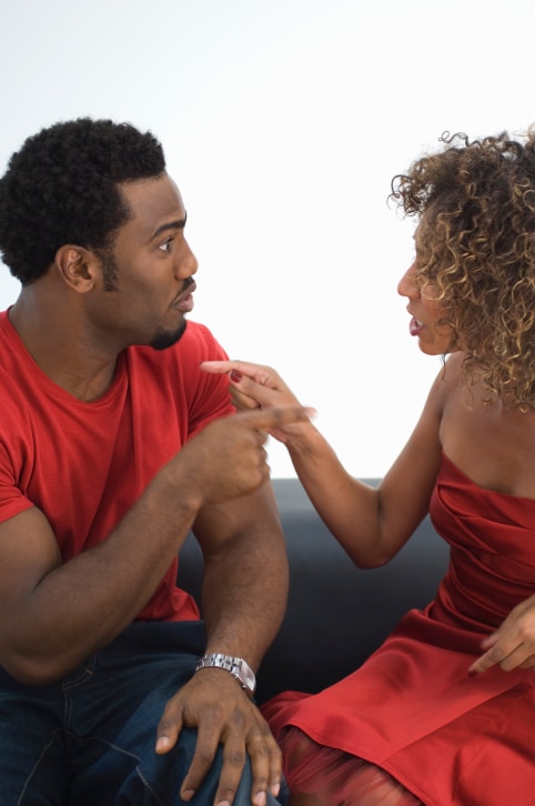 Man and woman pointing at one another