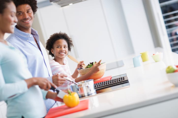 African American Black family in kitchen meal prepping