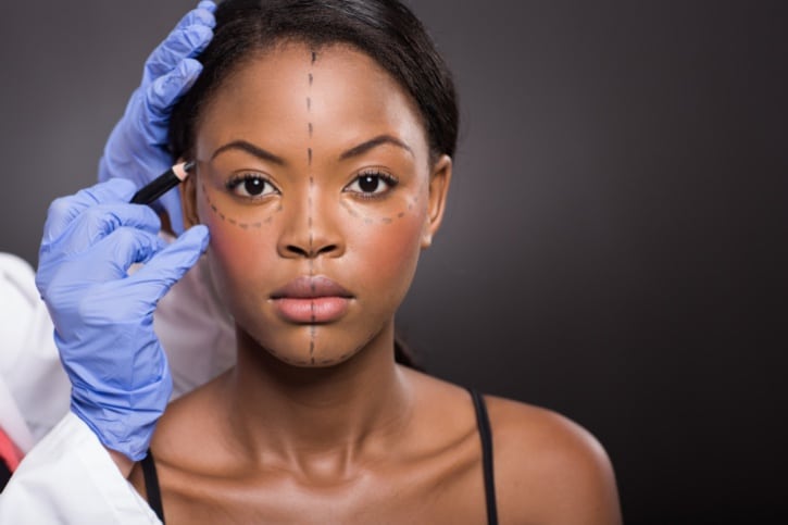 African American woman surgery correction marks on face