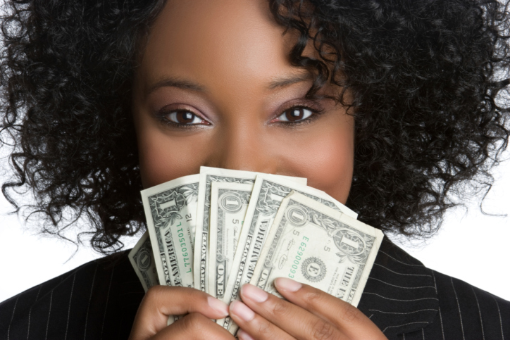 woman holding money up to her face