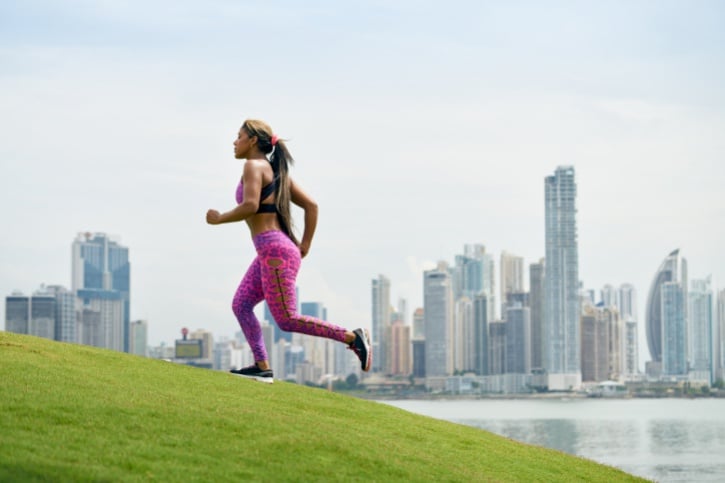 woman running outside in city