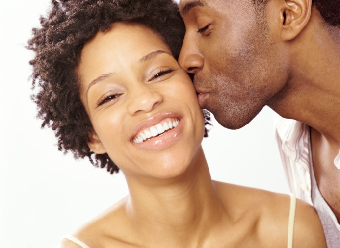 African American couple man kissing woman on cheek