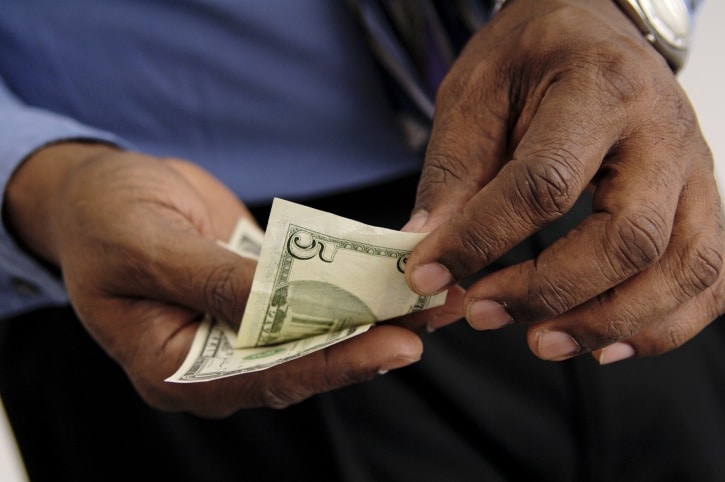 Older African American man counting money