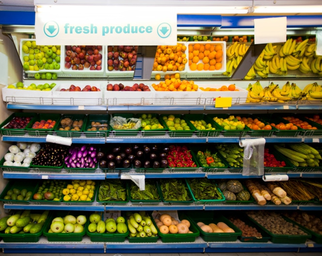 Various vegetables and fruits on display in grocery store