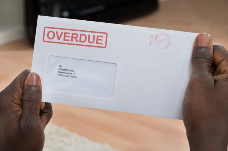 Person Holding Overdue Notice