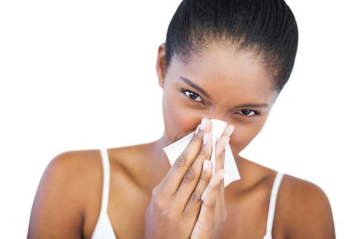 African American woman sneeze blowing nose