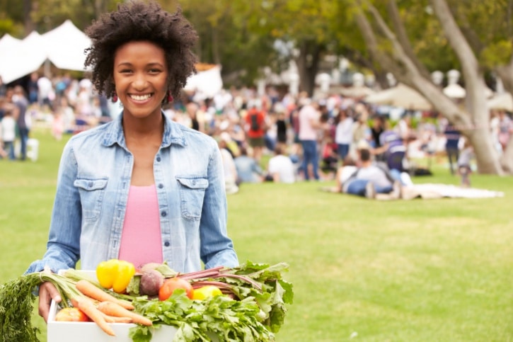 African American woman holding basket of vegetables