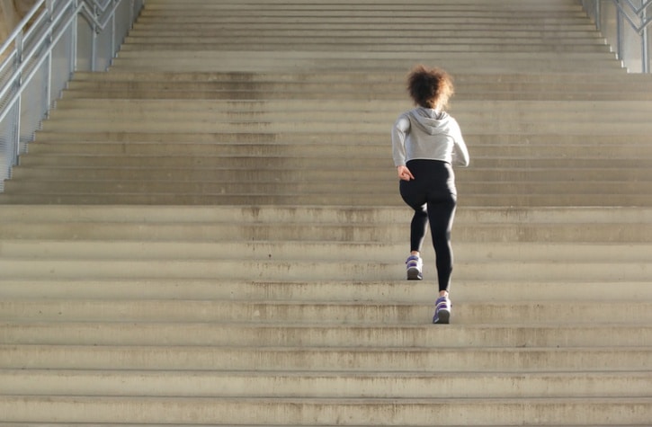 woman running up stairs