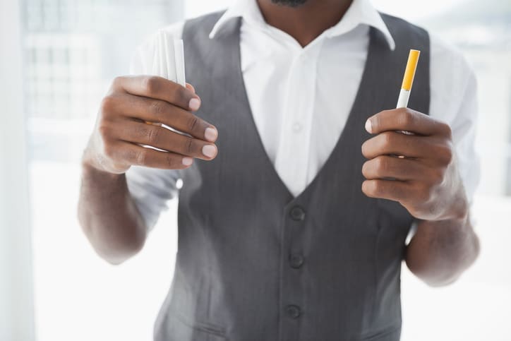 African american man holding cigarettes