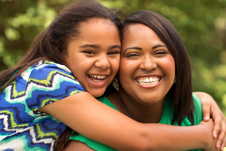 Mother and daughter hugging
