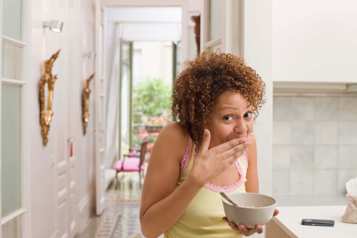 African American woman embarrassed eating