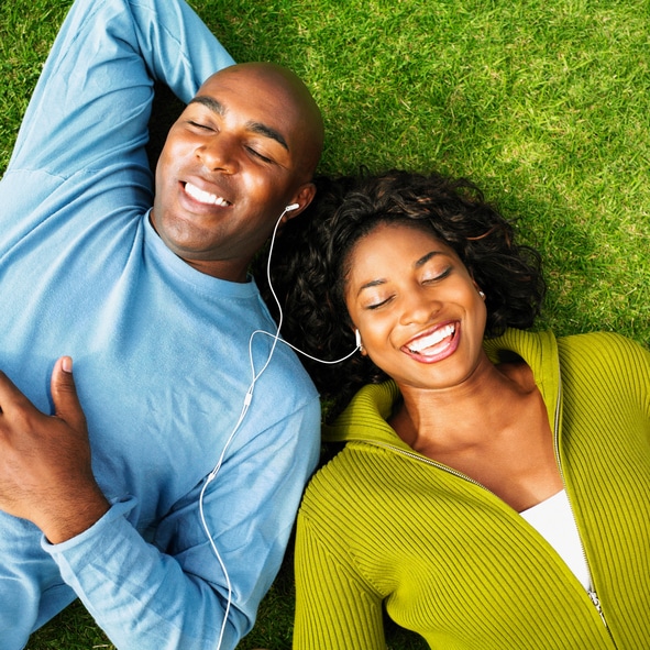 African American couple listening to music outside
