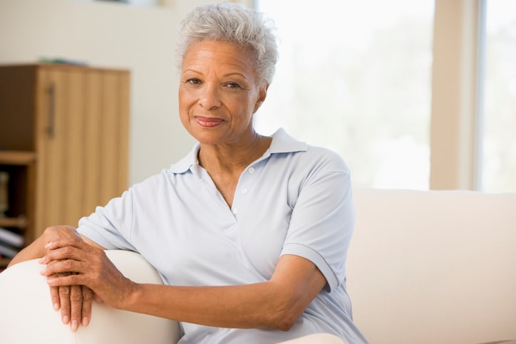 older African American woman sitting on couch