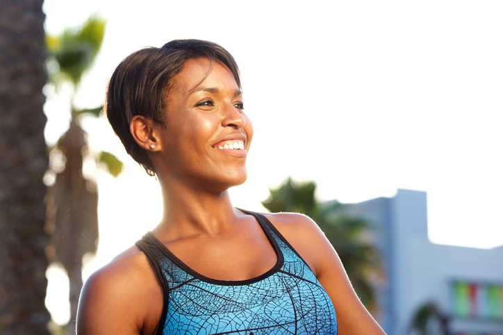 happy African American woman exercising outside