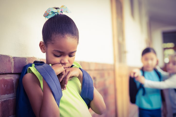 African American girl sad being bullied in school