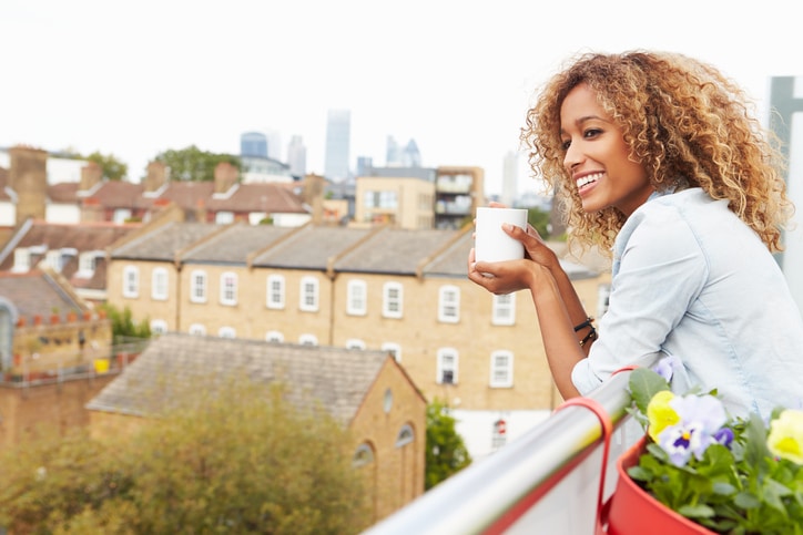 African American woman smiling on rooftop