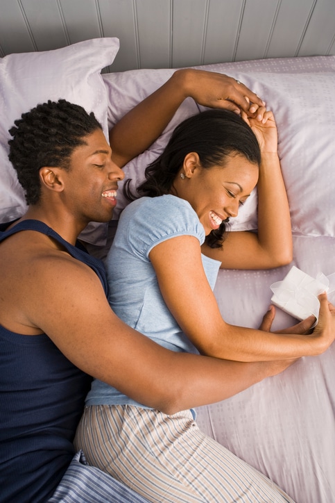 Couple laughing in bed