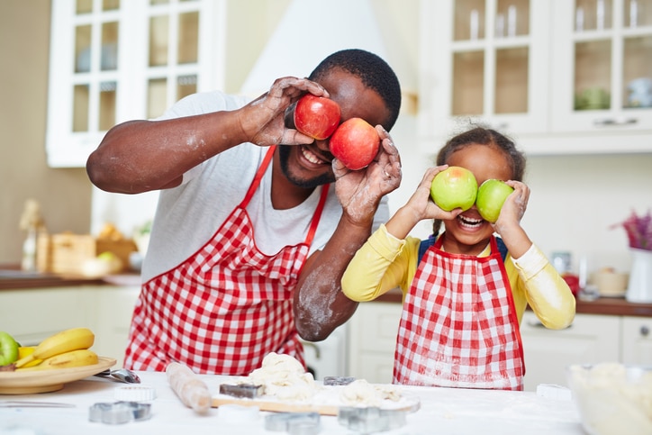 African American father and daughter cookingd