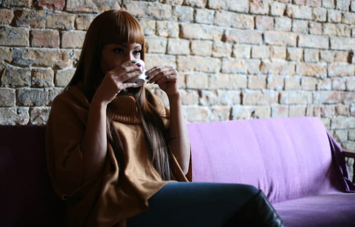woman drinking a cup of coffee or tea