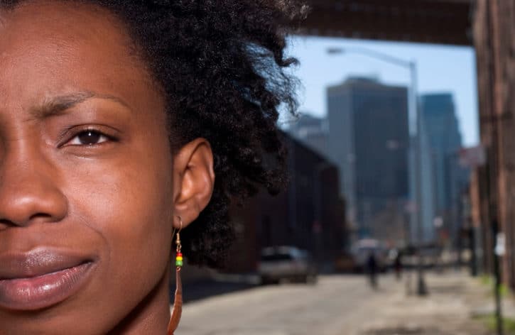 African American woman on city sidewalk