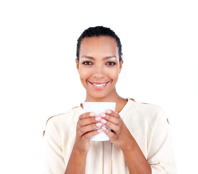 African American woman drinking cup smiling