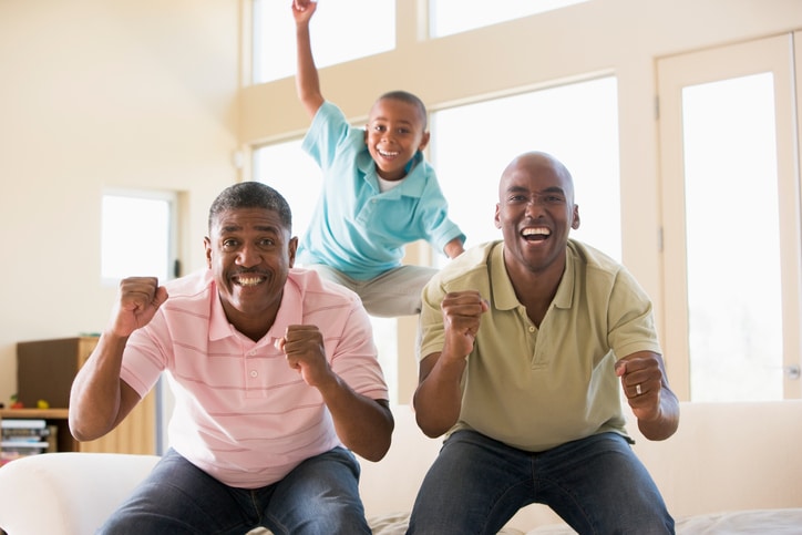 African American men watching football at home