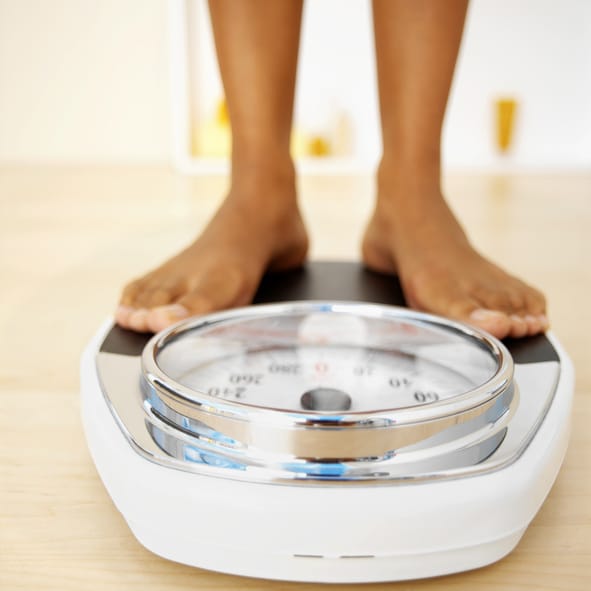 African American woman on scale