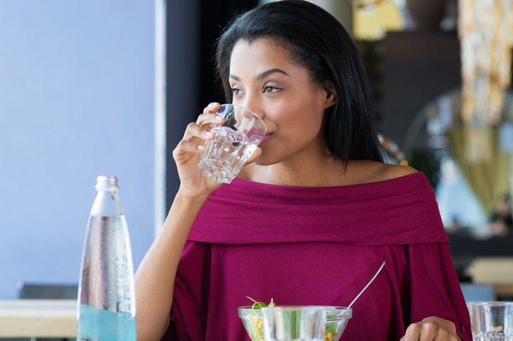 African American woman drinking water