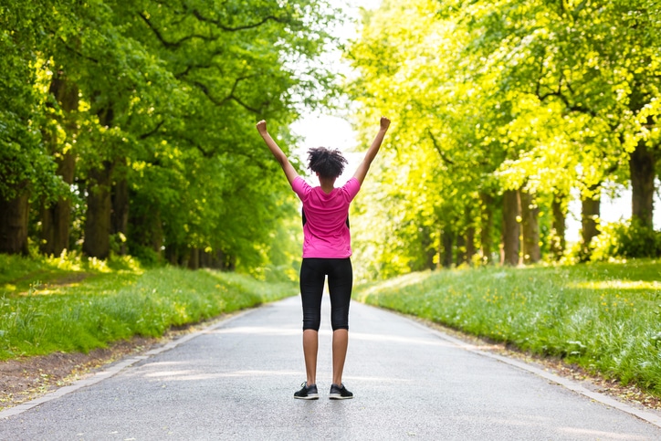 African American woman exercising outside spring summer