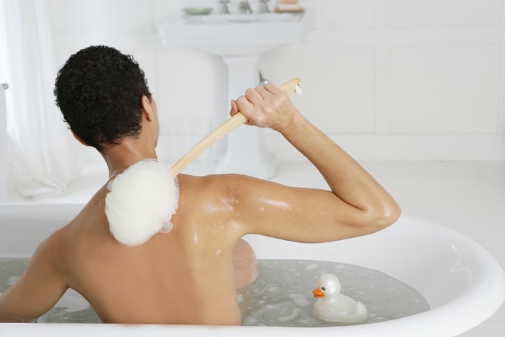 African American woman bathtub body scrub
