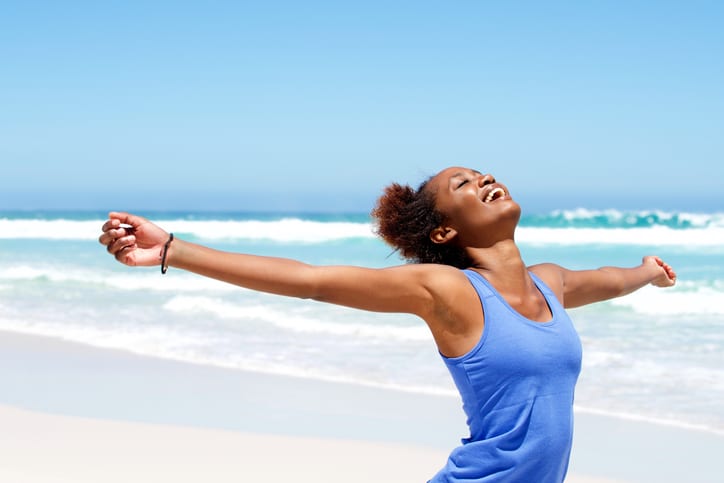 African American woman on beach happy carefree