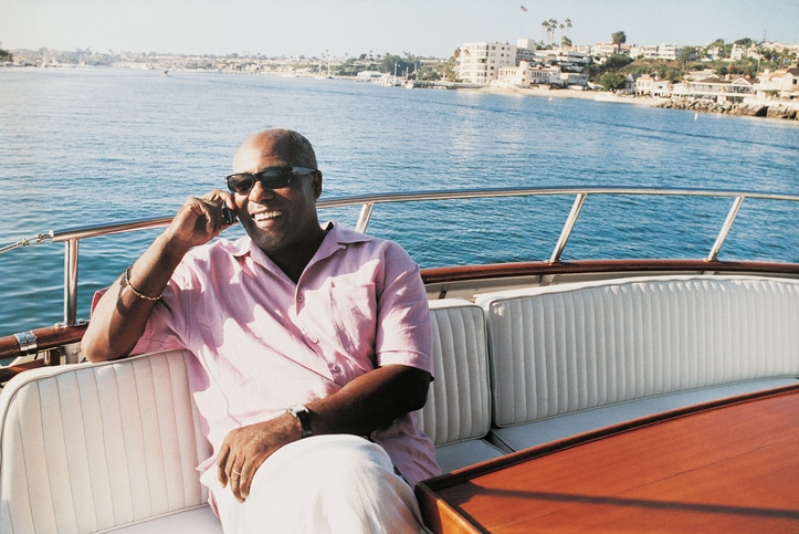 Older African American man on boat summer vacation