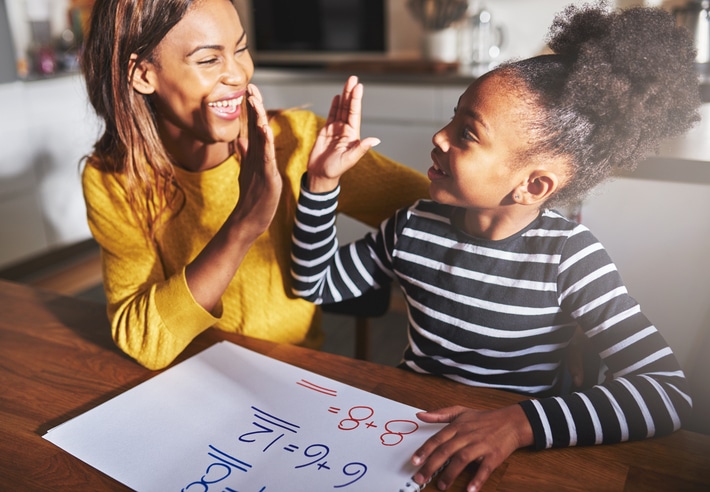 African American woman and child school work