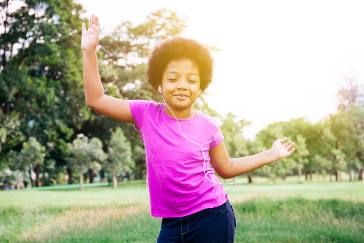 African American girl dancing happy outside
