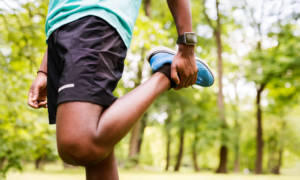 Runner stretching outdoors. 