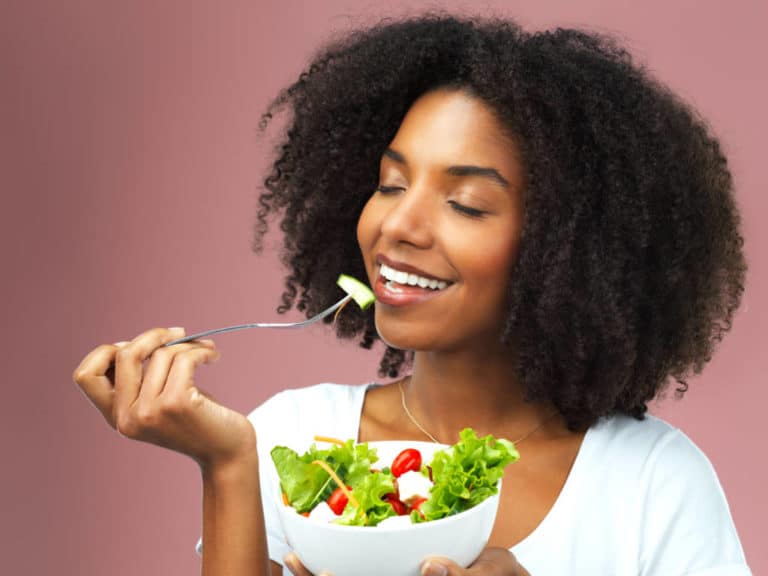 Woman eating salad.