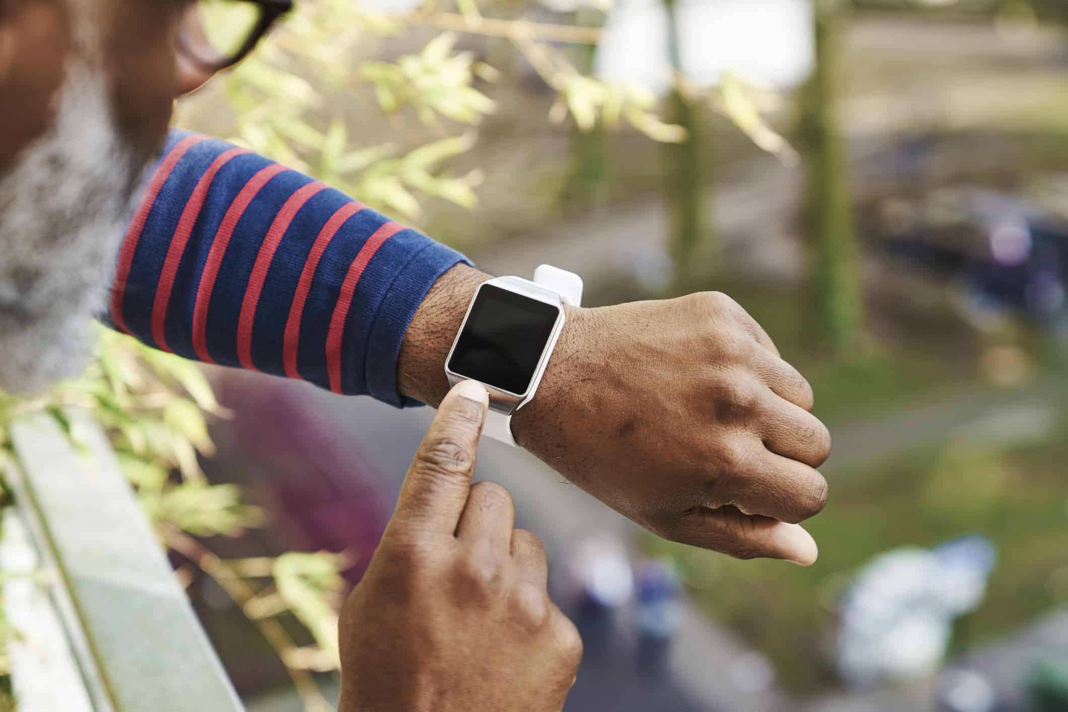 man looking at smartwatch