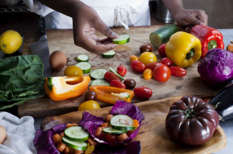 Chef holding a slice of cucumber