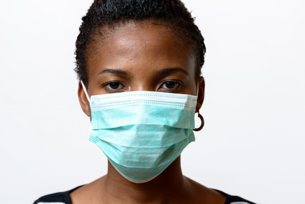 Young African woman wearing a face mas