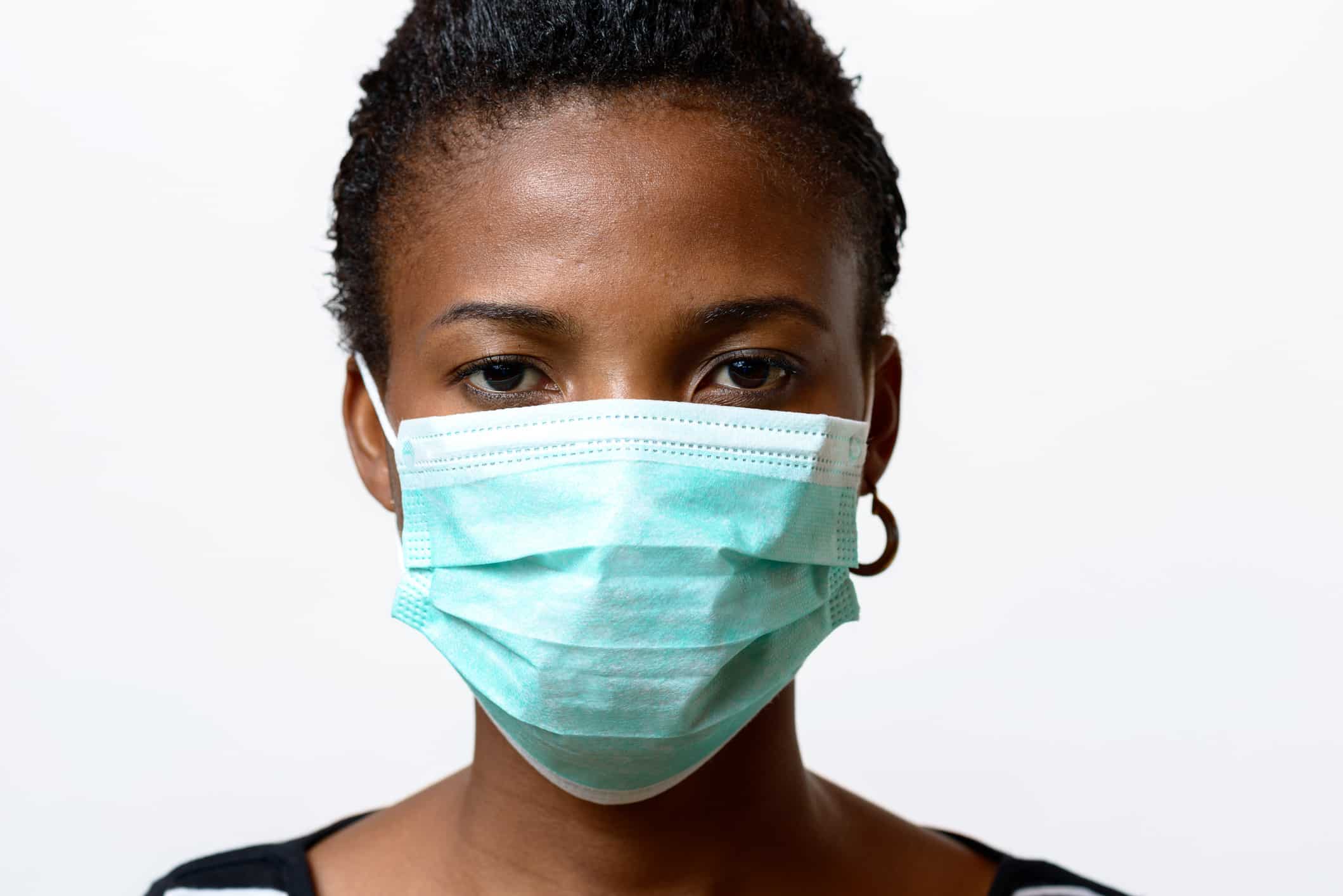 Young African woman wearing a face mas