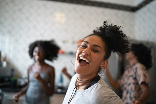 Black women dancing and hanging out.