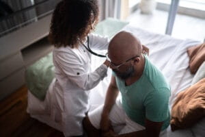 A black woman cardiologist checking her patient