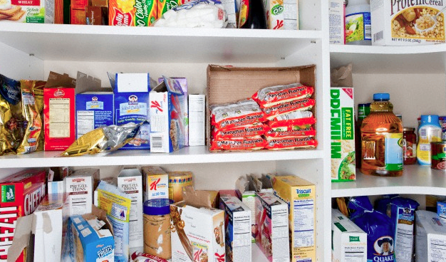 Different processed foods sitting in a kitchen cabinet